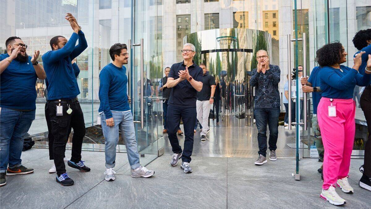 CEO Tim Cook (Mitte) beklatscht vor dem Apple Store an der New Yorker Fifth Avenue den Firmenerfolg.