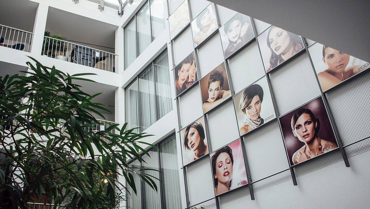 Die Eingangshalle von Artdeco Cosmetic in Karlsfeld ist geschmückt mit Looks aus letzten Jahrzehnten